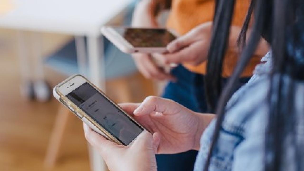 two people collecting data on a device
