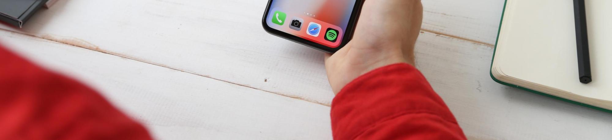 A hand holding an iPhone